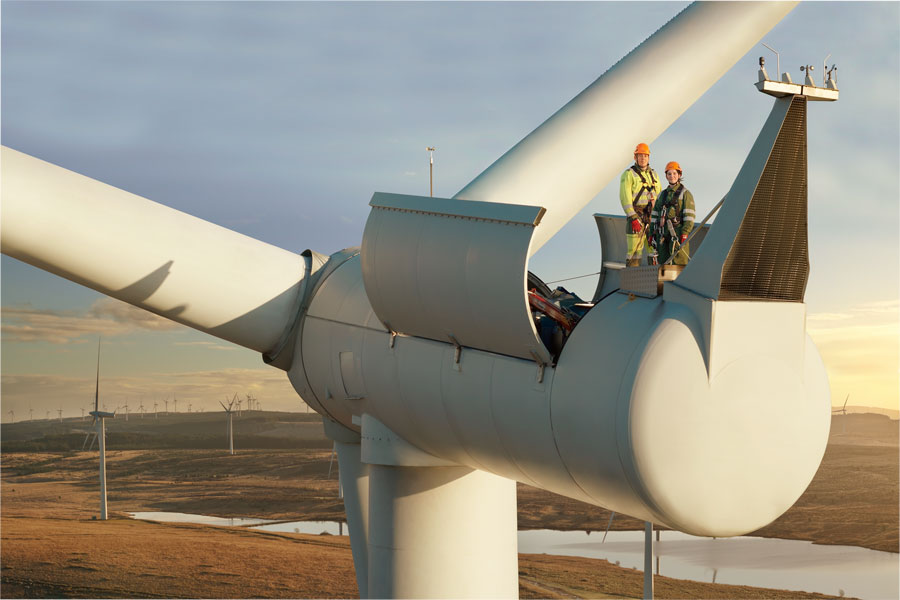Ben Findley and Hope Ross stand on top of a wind turbine