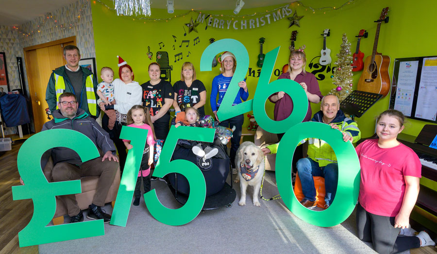 Members of CHAS Charity hold up large numbers showing a donation amount of £15260