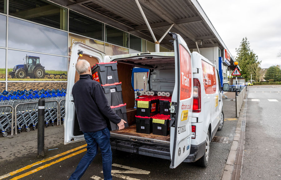 Food Train volunteers load their delivery van