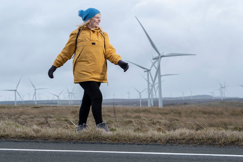 Michele Lennox walks through a windfarm