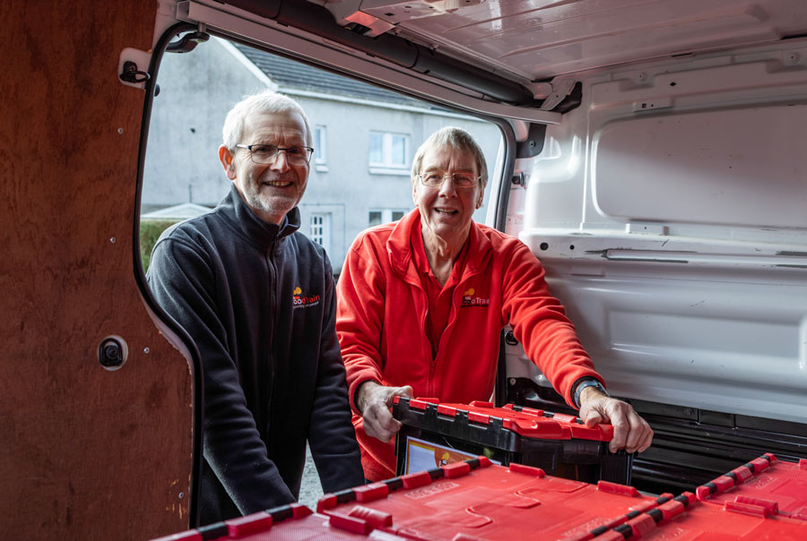 Food Train volunteers load their delivery van